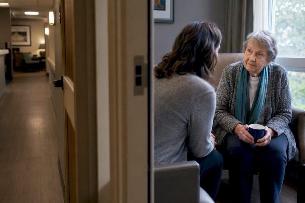 Family member speaking privately with nursing home resident